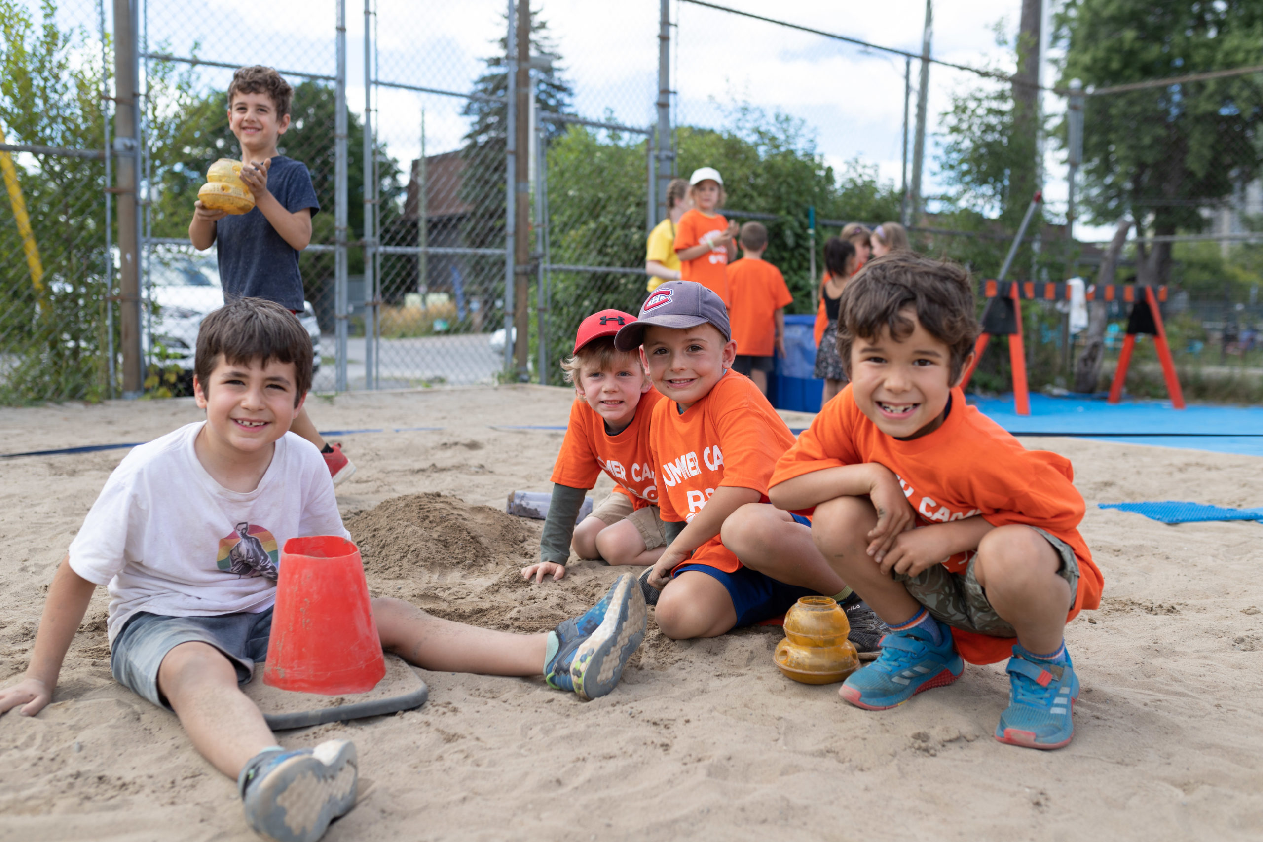boys playing outside in the sand at sports camp