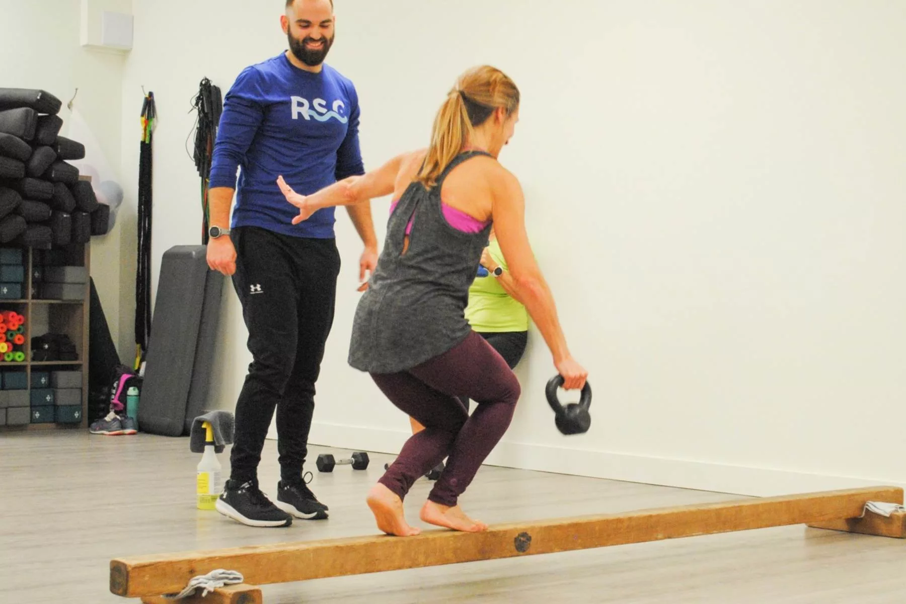 fitness class instructor teaching a woman