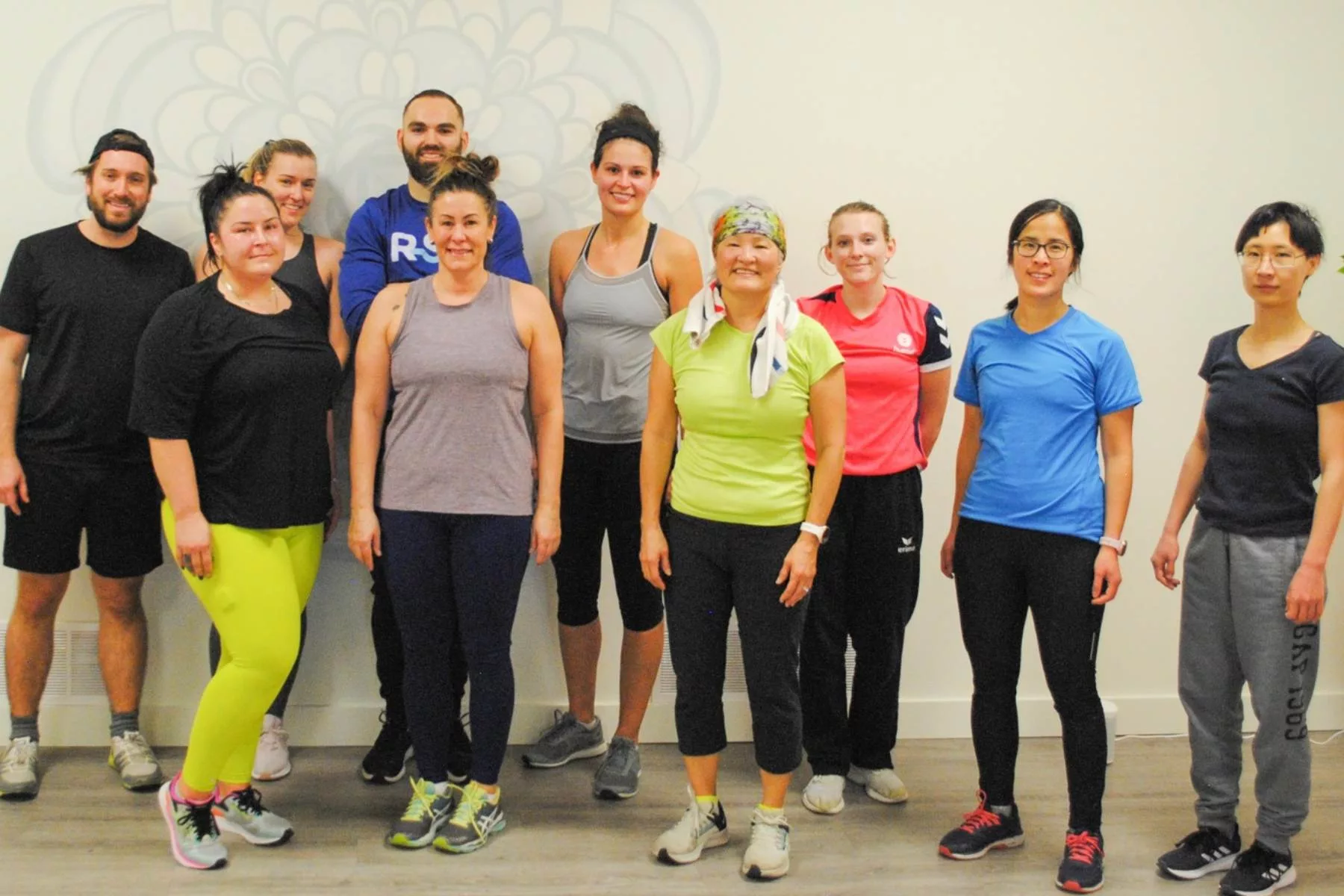 group fitness class participants smiling after workout